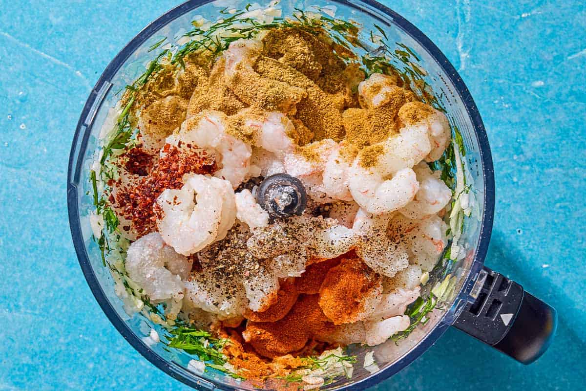 The ingredients for the shrimp kofta in the bowl of a food processor just before being mixed together.
