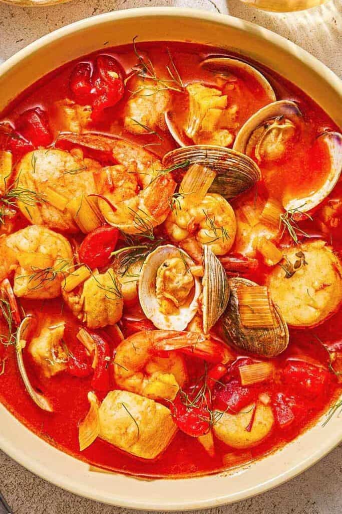 A serving of bouillabaisse in a bowl.