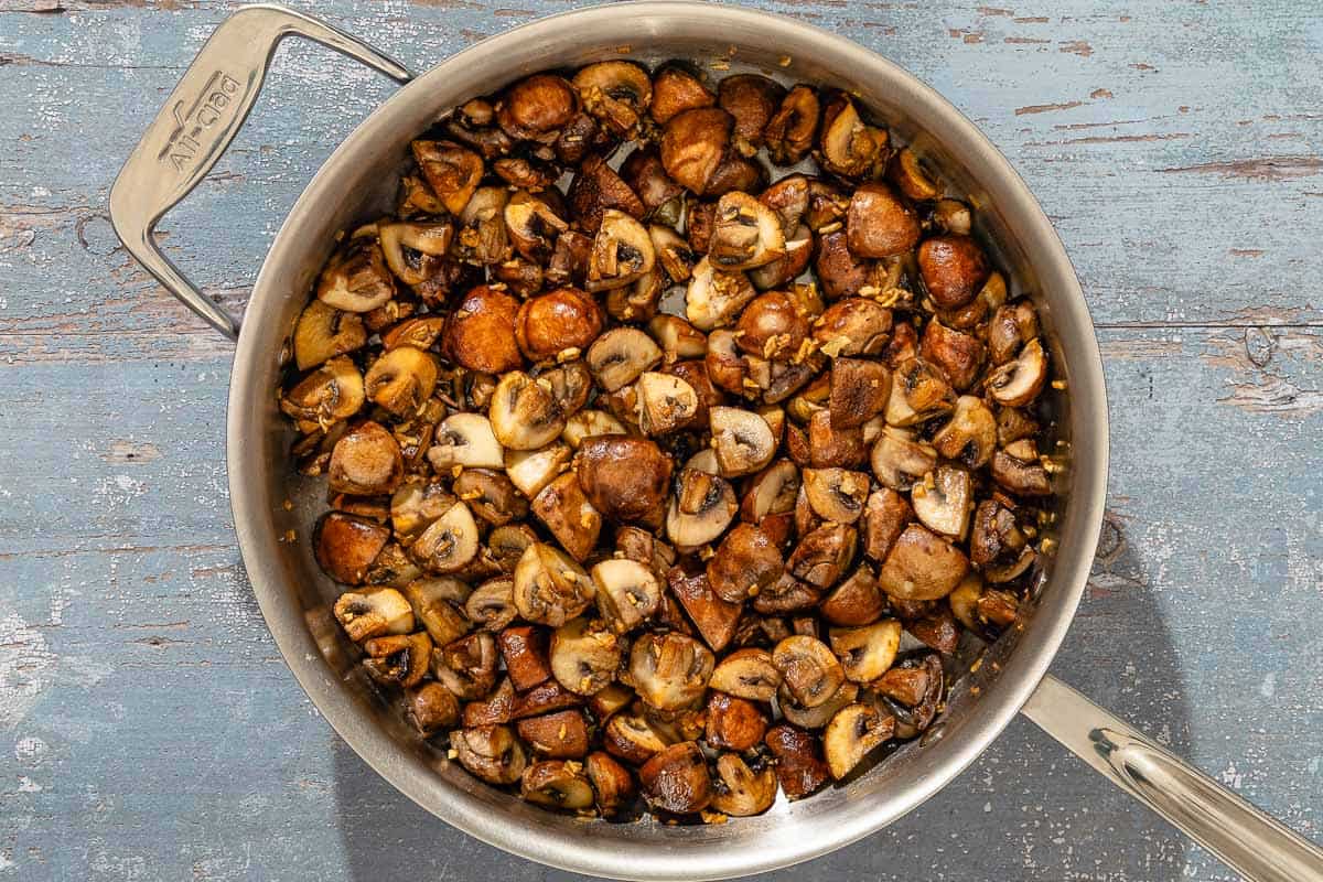 Spanish garlic mushrooms in a saucepan.