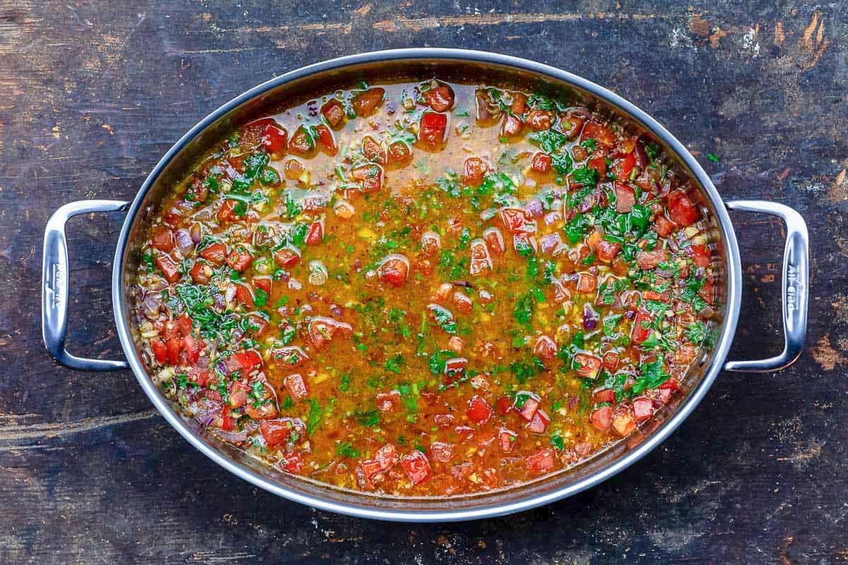 The sauce for the shrimp pasta in a tall sided skillet.