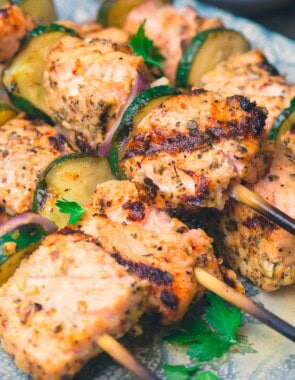A close up of salmon kabobs on a platter.