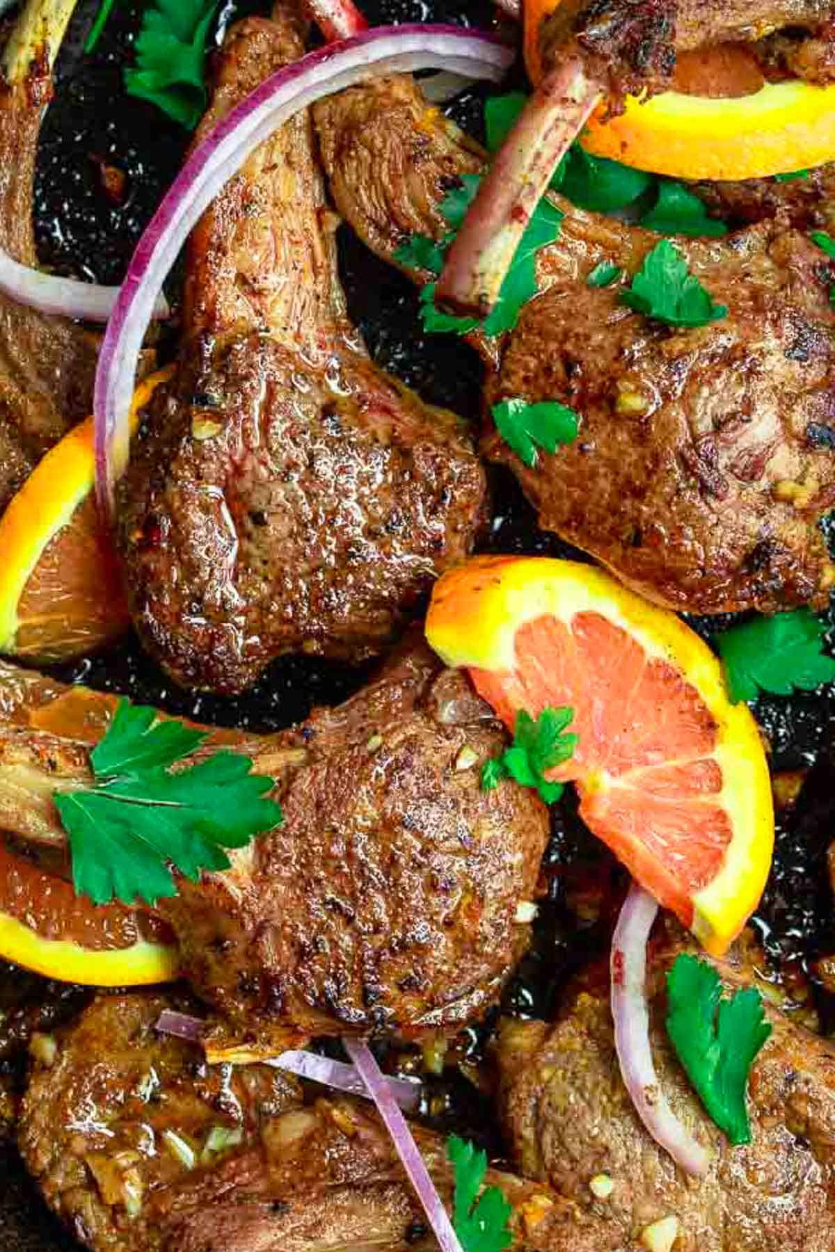 An overhead photo of the lamb chops recipe in a cast iron skillet.