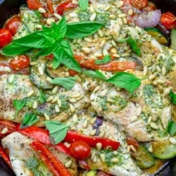 An overhead photo of the pesto chicken recipe in a cast iron skillet.
