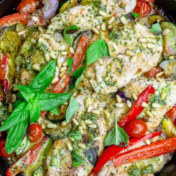 An overhead photo of the pesto chicken recipe in a cast iron skillet.