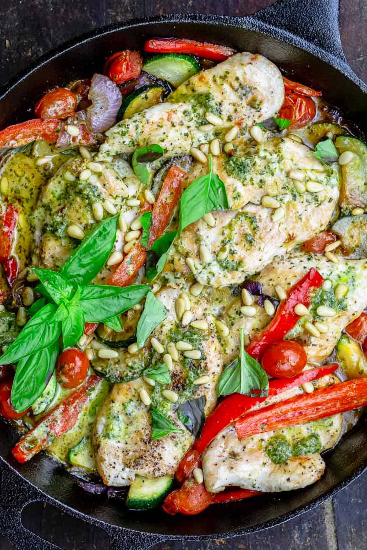 An overhead photo of the pesto chicken recipe in a cast iron skillet.