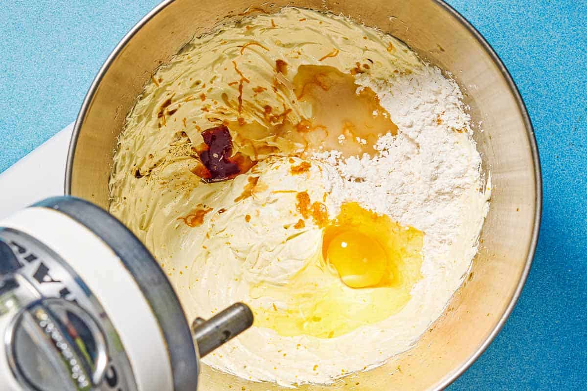 The ingredients for the almond cookies in the bowl of a stand mixer before being mixed together.