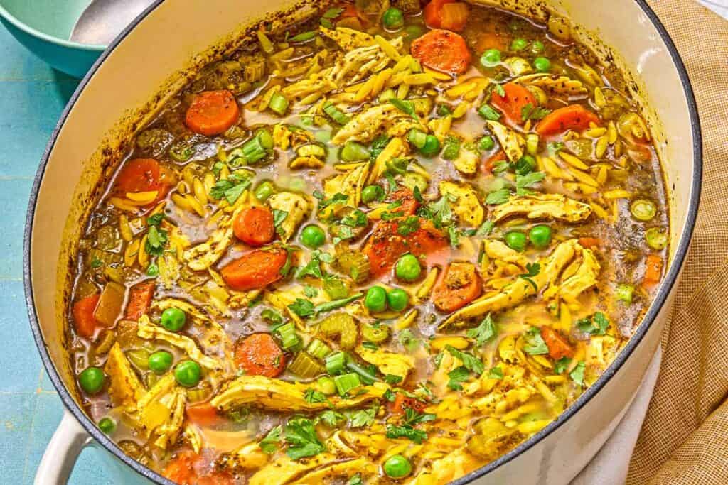 Chicken orzo soup in a pot.