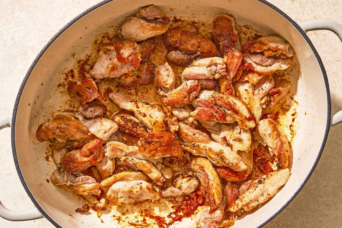 The chicken for the chicken risotto being seared in a large pot.