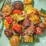 An overhead photo of a serving of the roasted vegetables recipe on a plate with a fork.