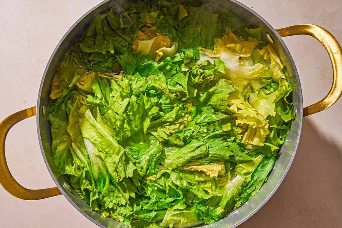 The greens for the utica green recipe being blanched in a pot of water.