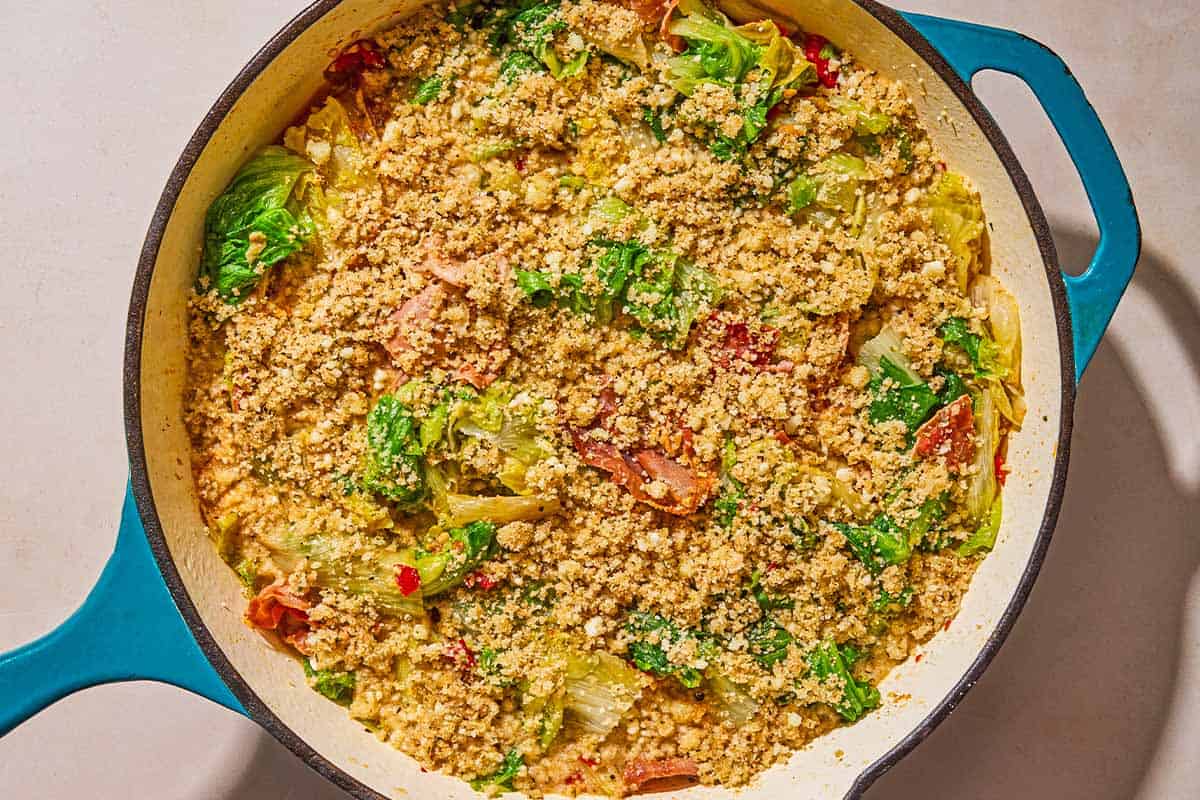 The unbroiled utica greens in a skillet.