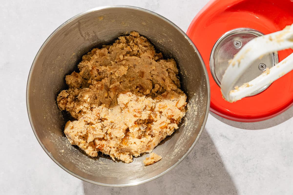The dough for the apricot cookie recipe in a the bowl of a stand mixer.