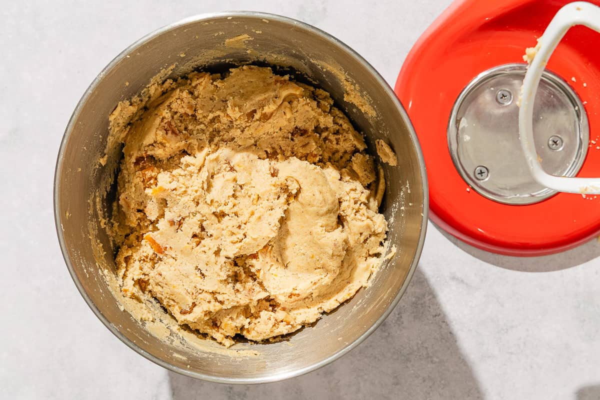 The dough for the apricot cookie recipe in a the bowl of a stand mixer.