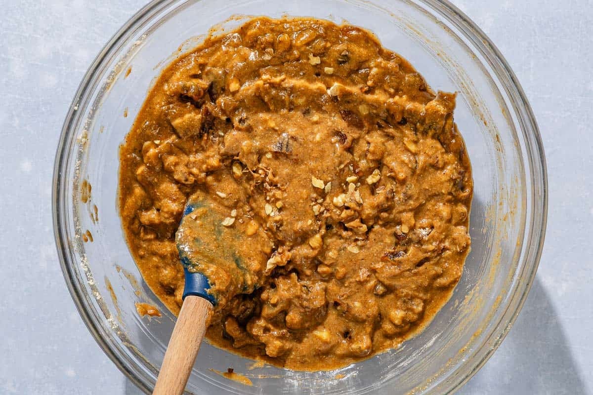 The batter for the date nut bread recipe in a bowl with a spatula.