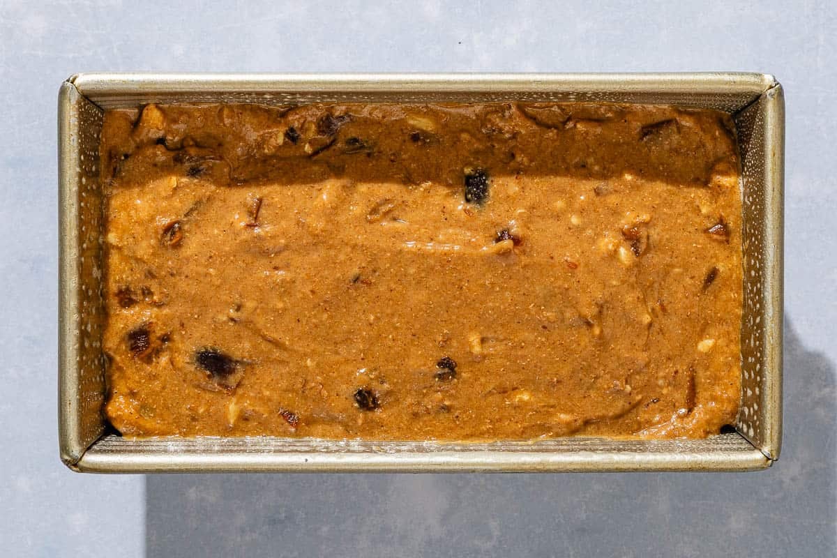 The unbaked date nut bread in a loaf pan.