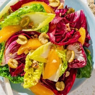A serving of the orange salad on a plate with a fork.