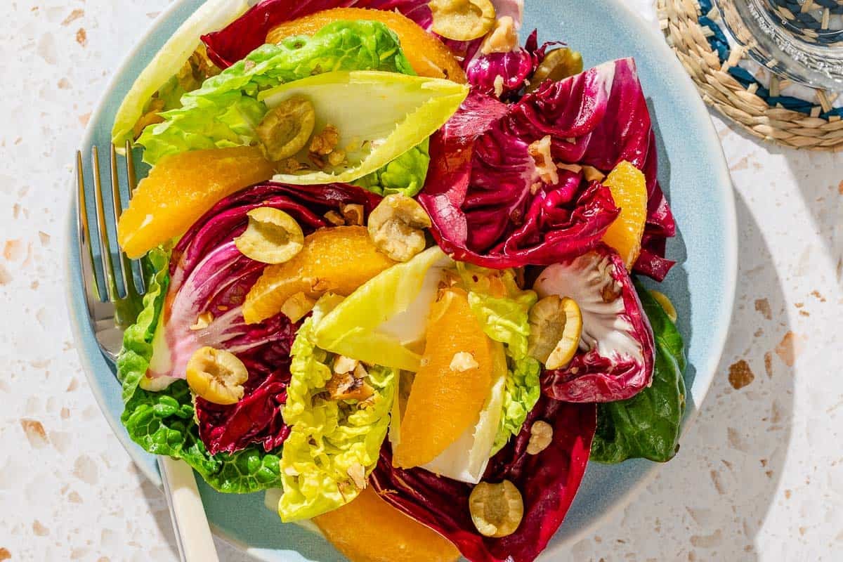 A serving of the orange salad on a plate with a fork.