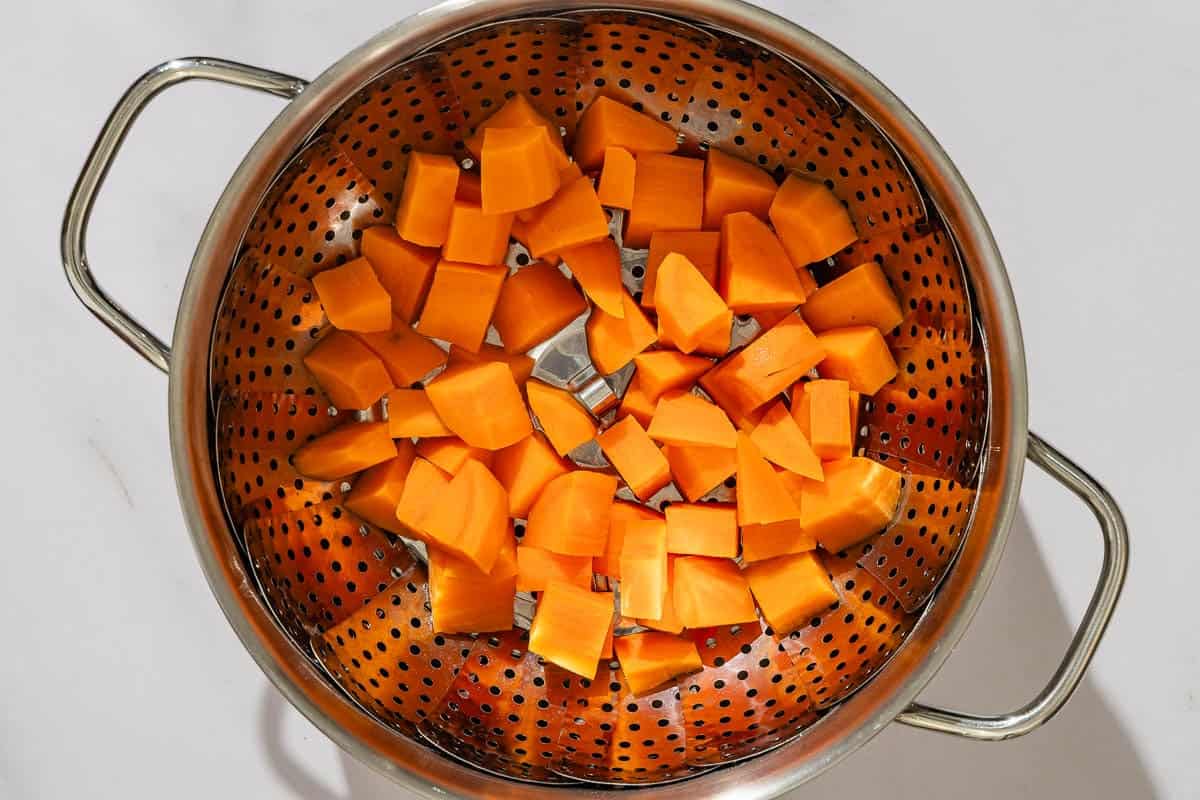 The cubed sweet potato pieces in a steamer.