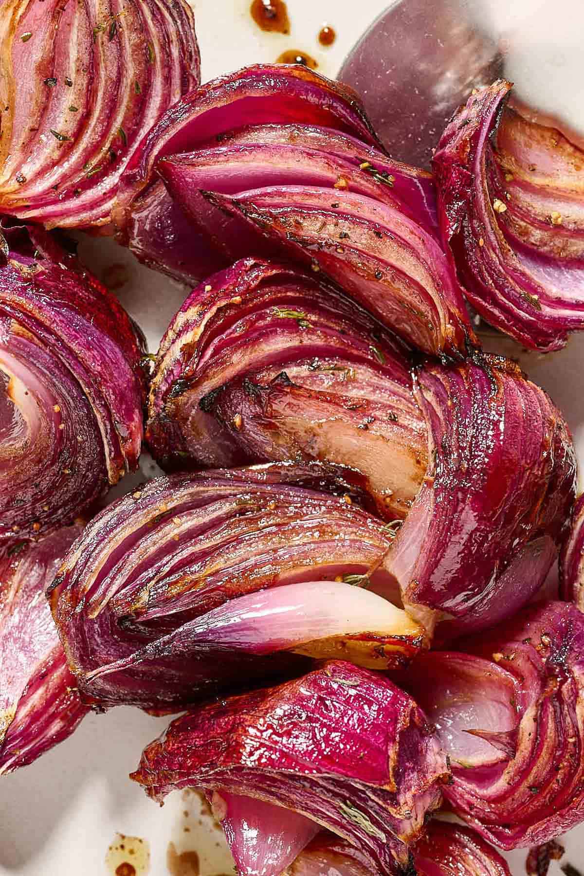 A close up of roasted red onions.
