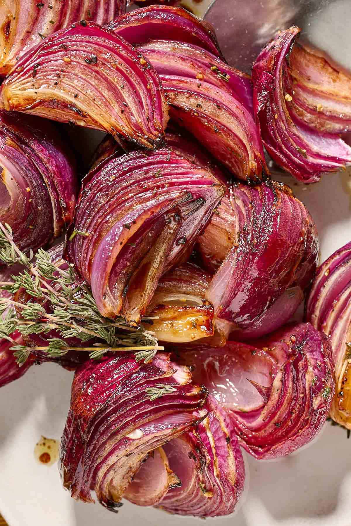 Roasted red onions on a platter.