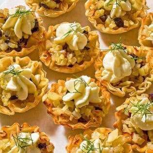 Several phyllo cups spread evenly on a platter.