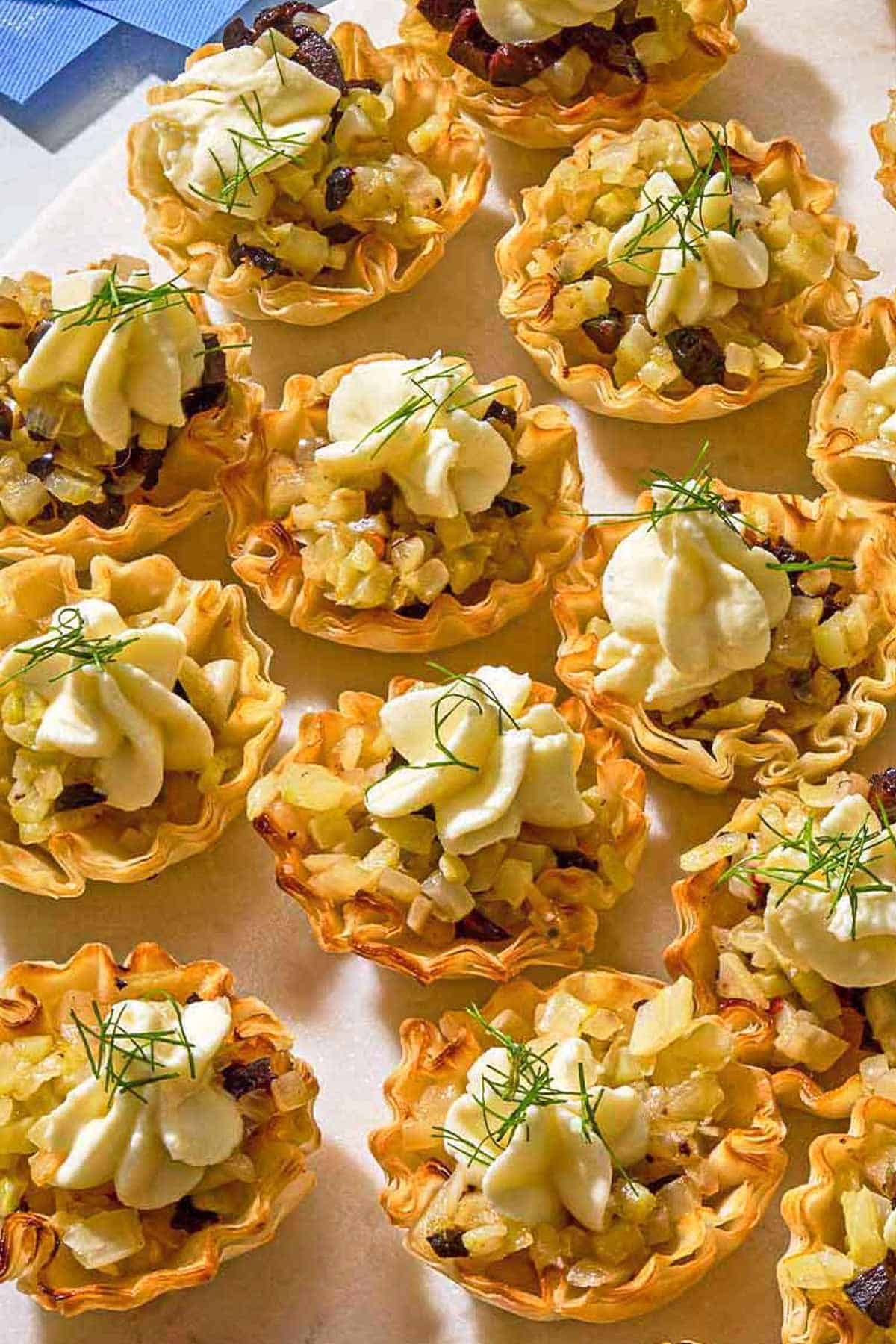 Several phyllo cups spread evenly on a platter.