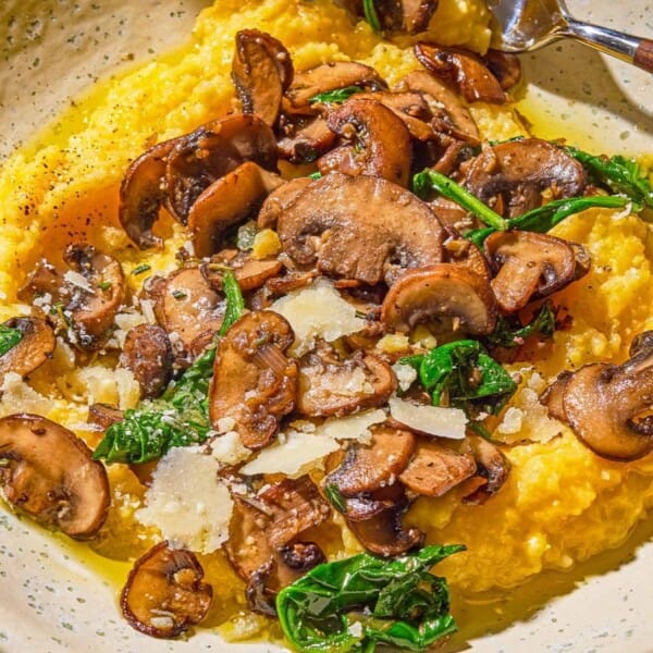 A plate of mushroom polenta with a fork.