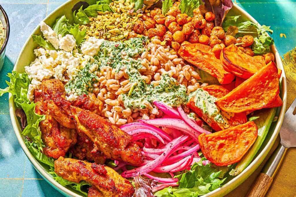 A sweet potato bowl next to a fork on a napkin.