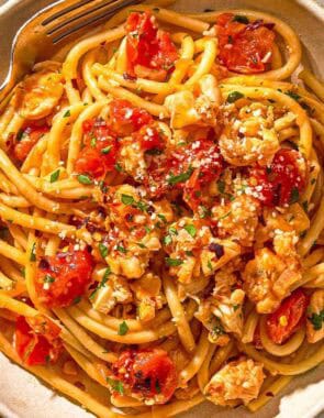 Lobster pasta in a bowl with a fork.
