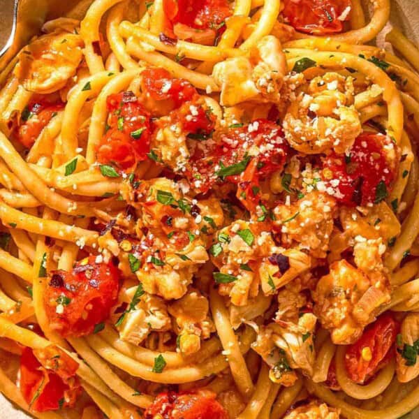 Lobster pasta in a bowl with a fork.
