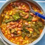 Collard green soup in a bowl with a spoon.