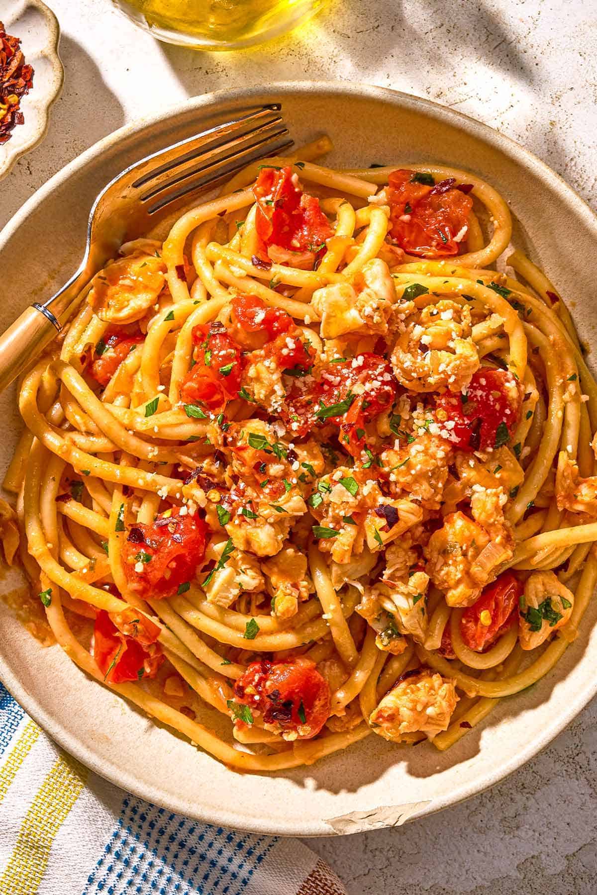 Lobster pasta in a bowl with a fork.