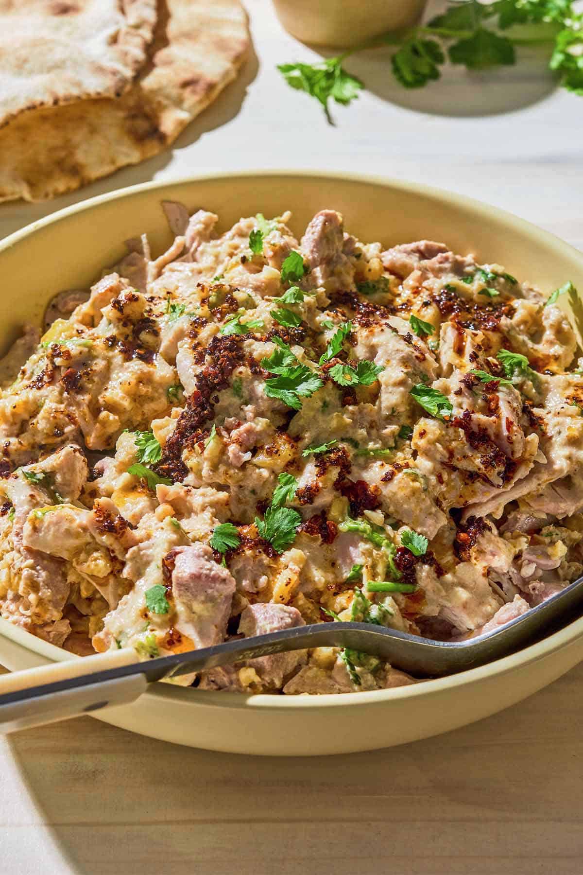 Circassian chicken in a bowl with a spoon.