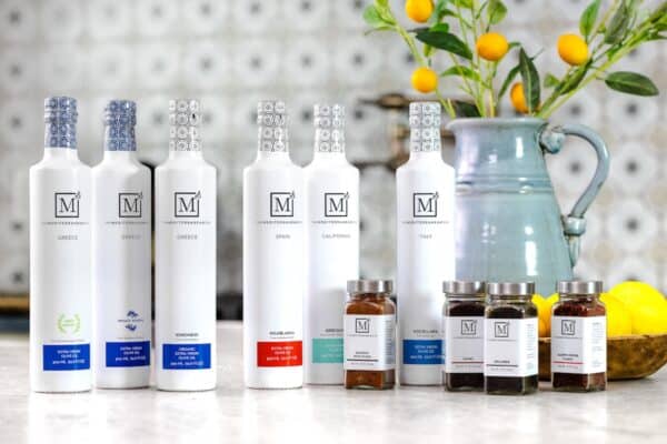 Bottle of The Mediterranean Dish olive oil and spices on a countertop.