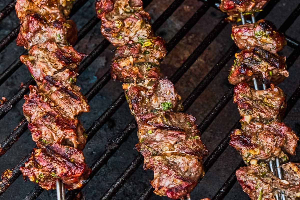 Cooked lamb kabobs on a grill.