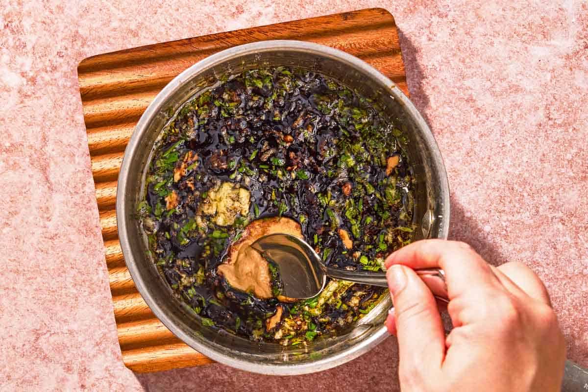 The glaze for the lamb ribs being stirred in a bowl.