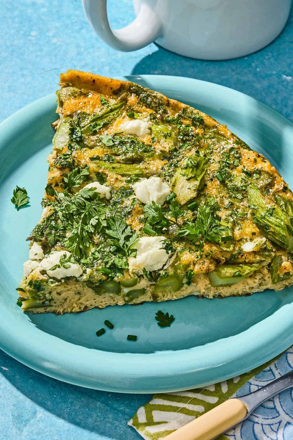 A slice of the asparagus frittata on a plate.