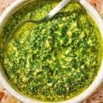 The basil pesto recipe in a bowl with a spoon.