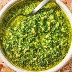 The basil pesto recipe in a bowl with a spoon.