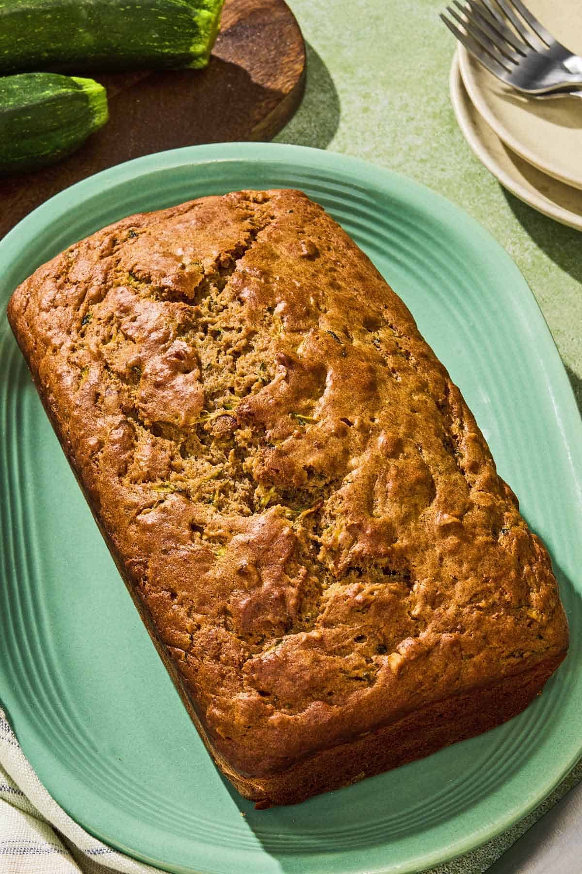 A loaf of zucchini bread on a platter.