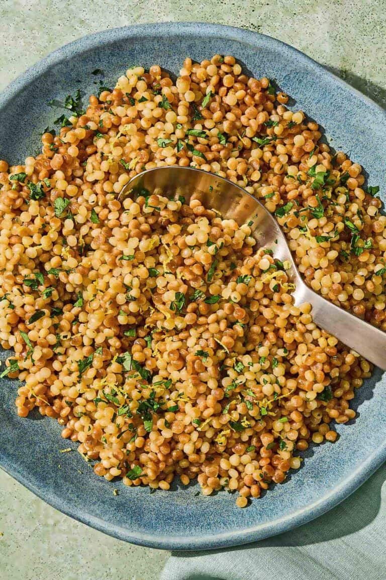 The pearl couscous recipe in a bowl with a spoon.