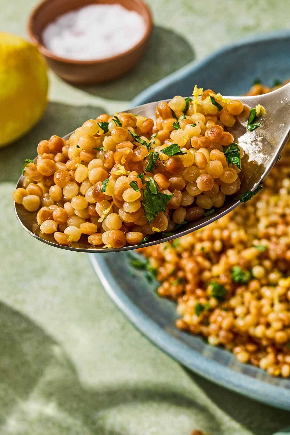 A close up of a spoonful of the pearl couscous recipe.