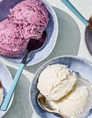 Bowls of tahini, blueberry, vanilla and chocolate hazelnut dairy free ice cream with spoons.