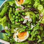 A serving of the spring green salad on a plate with a fork.
