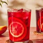 A glass of tinto de verano, a refreshing Spanish wine drink, on a coaster.