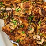 The chicken and mushroom recipe on a platter with a serving fork.