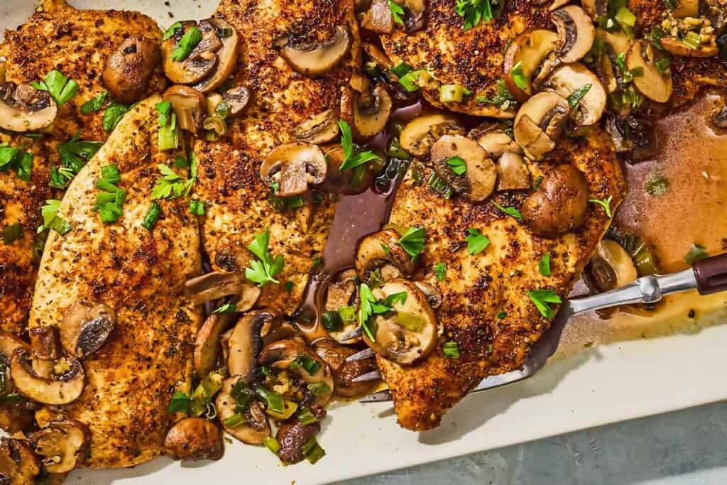 The chicken and mushroom recipe on a platter with a serving fork.
