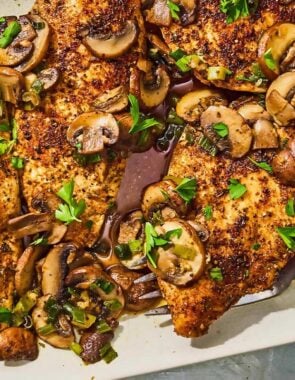 The chicken and mushroom recipe on a platter with a serving fork.