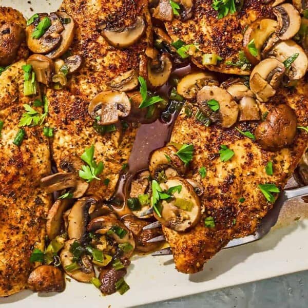 The chicken and mushroom recipe on a platter with a serving fork.