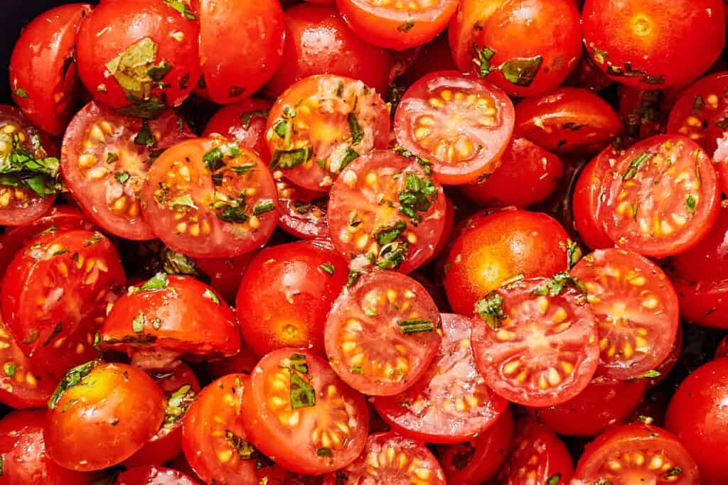 A close up of marinated tomatoes.